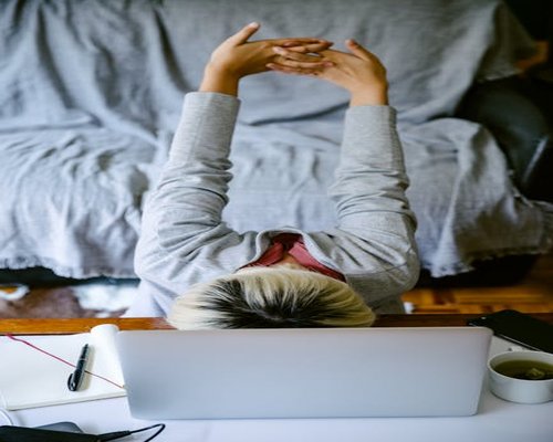 A person taking a relaxing break at their home office desk